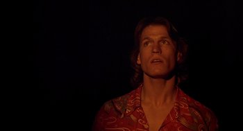 Movie still from “Xanadu” (1980), directed by Robert Greenwald – A man with long hair wearing a red shirt; Close Up shot, Low angle