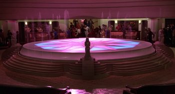 Movie still from “Xanadu” (1980), directed by Robert Greenwald – A stage with lights and people standing around it; Extreme Wide shot, High angle