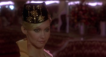 Movie still from “Xanadu” (1980), directed by Robert Greenwald – A woman wearing a hat and a yellow dress; Close Up shot, Low angle