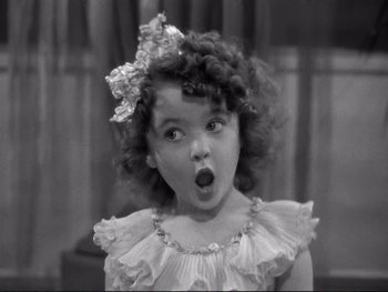 Movie still from “Yankee Doodle Dandy” (1942), directed by Michael Curtiz – A little girl with a surprised look on her face; Close Up shot, High angle