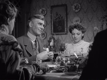 Movie still from “Yankee Doodle Dandy” (1942), directed by Michael Curtiz – A man and a woman sitting at a dinner table; Medium shot, Over the shoulder angle