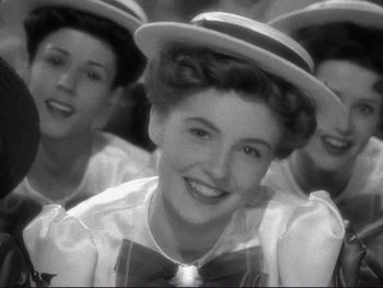 Movie still from “Yankee Doodle Dandy” (1942), directed by Michael Curtiz – A group of women wearing hats and bow ties; Close Up shot, Low angle