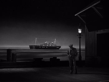 Movie still from “Yankee Doodle Dandy” (1942), directed by Michael Curtiz – A man standing next to a street light and looking at a ship; Extreme Wide shot, Low angle