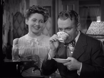 Movie still from “Yankee Doodle Dandy” (1942), directed by Michael Curtiz – A man and a woman are drinking coffee; Medium shot, Low angle