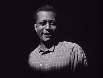 Movie still from “Yankee Doodle Dandy” (1942), directed by Michael Curtiz – A black and white photo of a man smiling; Close Up shot, Low angle
