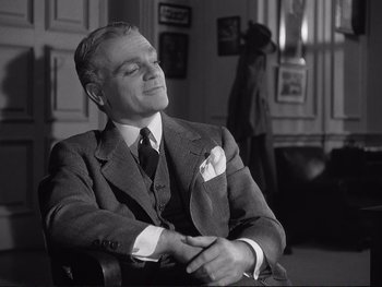Movie still from “Yankee Doodle Dandy” (1942), directed by Michael Curtiz – An older man sitting in a chair with his eyes closed; Medium shot, Over the shoulder angle
