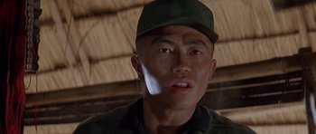 Movie still from “Year of the Dragon” (1985), directed by Michael Cimino – A person wearing a hat; Close Up shot, Low angle