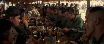 Movie still from “Year of the Dragon” (1985), directed by Michael Cimino – A group of men sitting at a table eating food; Medium shot, High angle