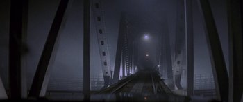 Movie still from “Year of the Dragon” (1985), directed by Michael Cimino – A train track in the middle of the night; Extreme Wide shot, High angle