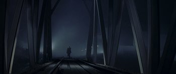 Movie still from “Year of the Dragon” (1985), directed by Michael Cimino – A person walking across a bridge at night; Extreme Wide shot, High angle