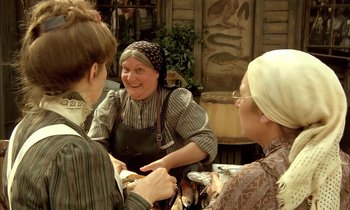 Movie still from “Yentl” (1983), directed by Barbra Streisand – A group of women sitting around a table; Medium shot, Over the shoulder angle