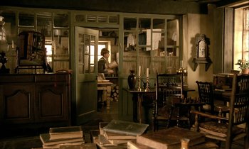 Movie still from “Yentl” (1983), directed by Barbra Streisand – An old man sitting at a table in a room; Wide shot, High angle