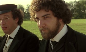 Movie still from “Yentl” (1983), directed by Barbra Streisand – A man with a beard and a suit; Close Up shot, Over the shoulder angle