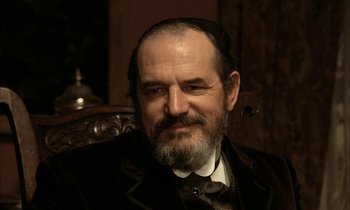 Movie still from “Yentl” (1983), directed by Barbra Streisand – An older man with a beard and a hat; Close Up shot, Low angle