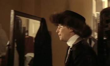Movie still from “Yentl” (1983), directed by Barbra Streisand – A man wearing a fur hat and a tie; Close Up shot, Over the shoulder angle