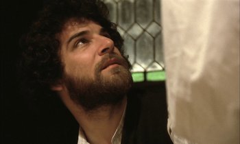 Movie still from “Yentl” (1983), directed by Barbra Streisand – A man with a goatee looks up into the sky; Close Up shot, Low angle