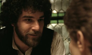 Movie still from “Yentl” (1983), directed by Barbra Streisand – A person with a beard; Close Up shot, Over the shoulder angle