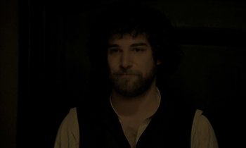 Movie still from “Yentl” (1983), directed by Barbra Streisand – A man with a beard is looking at the camera; Close Up shot, Over the shoulder angle