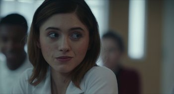 Movie still from “Yes, God, Yes” (2019), directed by Karen Maine – A person sitting in front of a window; Close Up shot, Over the shoulder angle