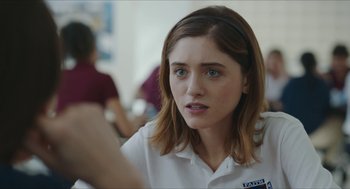 Movie still from “Yes, God, Yes” (2019), directed by Karen Maine – A person wearing a white shirt; Close Up shot, Over the shoulder angle