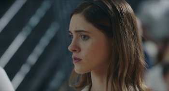 Movie still from “Yes, God, Yes” (2019), directed by Karen Maine – A person with long brown hair; Close Up shot, Over the shoulder angle