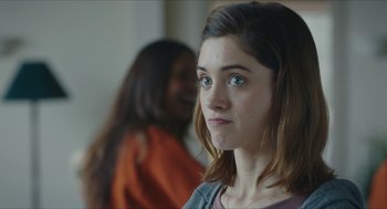 Movie still from “Yes, God, Yes” (2019), directed by Karen Maine – A young woman with green eyes looking to her left; Close Up shot, Over the shoulder angle