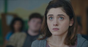 Movie still from “Yes, God, Yes” (2019), directed by Karen Maine – A young woman with blue eyes stares into the distance; Close Up shot, Over the shoulder angle