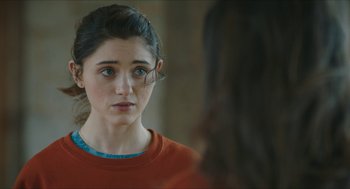Movie still from “Yes, God, Yes” (2019), directed by Karen Maine – A woman looking at her reflection in a mirror; Close Up shot, Over the shoulder angle