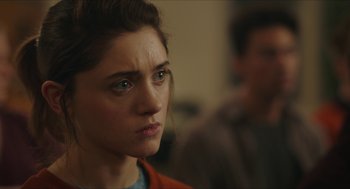 Movie still from “Yes, God, Yes” (2019), directed by Karen Maine – A person looking at the camera; Close Up shot, Over the shoulder angle