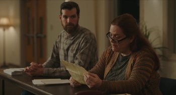 Movie still from “Yes, God, Yes” (2019), directed by Karen Maine – A man and a woman sitting at a table; Medium shot, Over the shoulder angle