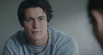 Movie still from “Yes, God, Yes” (2019), directed by Karen Maine – A person wearing a necklace; Close Up shot, Low angle