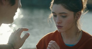 Movie still from “Yes, God, Yes” (2019), directed by Karen Maine – A woman is praying with her hand up to her chest; Close Up shot, Over the shoulder angle
