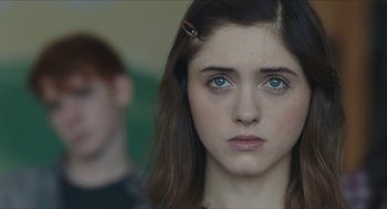 Movie still from “Yes, God, Yes” (2019), directed by Karen Maine – A person with blue eyes; Close Up shot, Over the shoulder angle