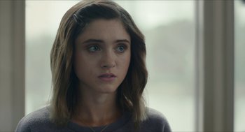 Movie still from “Yes, God, Yes” (2019), directed by Karen Maine – A person with long brown hair; Close Up shot, Over the shoulder angle