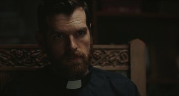 Movie still from “Yes, God, Yes” (2019), directed by Karen Maine – A person with a beard; Close Up shot, Over the shoulder angle