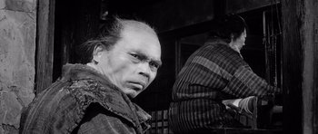 Movie still from “Yojimbo” (1961), directed by Akira Kurosawa – An old man with a beard and a mustache; Close Up shot, Low angle