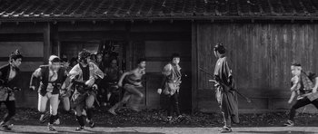 Movie still from “Yojimbo” (1961), directed by Akira Kurosawa – A group of people standing in front of a building; Wide shot, High angle