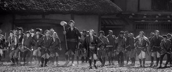 Movie still from “Yojimbo” (1961), directed by Akira Kurosawa – A group of people in traditional japanese garb; Wide shot, Low angle