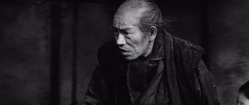 Movie still from “Yojimbo” (1961), directed by Akira Kurosawa – An old man with a beard and a long mustache; Close Up shot, Low angle