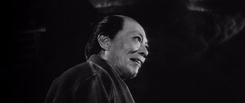 Movie still from “Yojimbo” (1961), directed by Akira Kurosawa – An older man is smiling and looking up at the sky; Close Up shot, Low angle