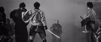 Movie still from “Yojimbo” (1961), directed by Akira Kurosawa – Two men are playing baseball in the fog; Medium shot, Over the shoulder angle