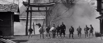 Movie still from “Yojimbo” (1961), directed by Akira Kurosawa – A black and white photo of a group of men in samurai garb; Wide shot, Low angle