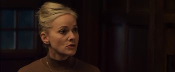 Movie still from “You're Next” (2011), directed by Adam Wingard – A woman with blonde hair is looking to her left; Close Up shot, Over the shoulder angle