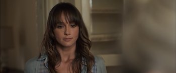 Movie still from “You're Next” (2011), directed by Adam Wingard – A person with long brown hair; Close Up shot, Over the shoulder angle