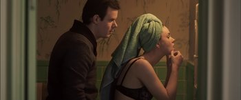 Movie still from “You're Next” (2011), directed by Adam Wingard – A man and a woman in a bathroom with a towel on their head; Medium shot, Over the shoulder angle