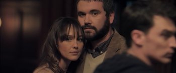 Movie still from “You're Next” (2011), directed by Adam Wingard – A man and a woman posing for a picture; Close Up shot, Over the shoulder angle
