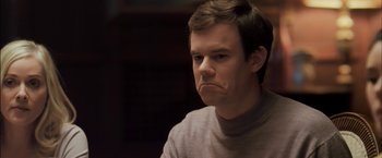 Movie still from “You're Next” (2011), directed by Adam Wingard – A man with a frowning look on his face; Close Up shot, Low angle