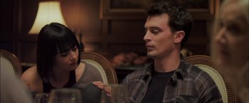 Movie still from “You're Next” (2011), directed by Adam Wingard – A man and a woman sitting at a dinner table; Close Up shot, Over the shoulder angle
