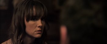 Movie still from “You're Next” (2011), directed by Adam Wingard – A person with long hair; Close Up shot, Over the shoulder angle