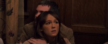 Movie still from “You're Next” (2011), directed by Adam Wingard – A man and a woman sitting next to each other in a room; Close Up shot, Over the shoulder angle